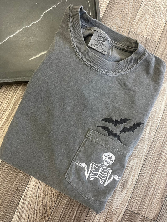 Batty Shrugging Skeleton Pocket Tshirt